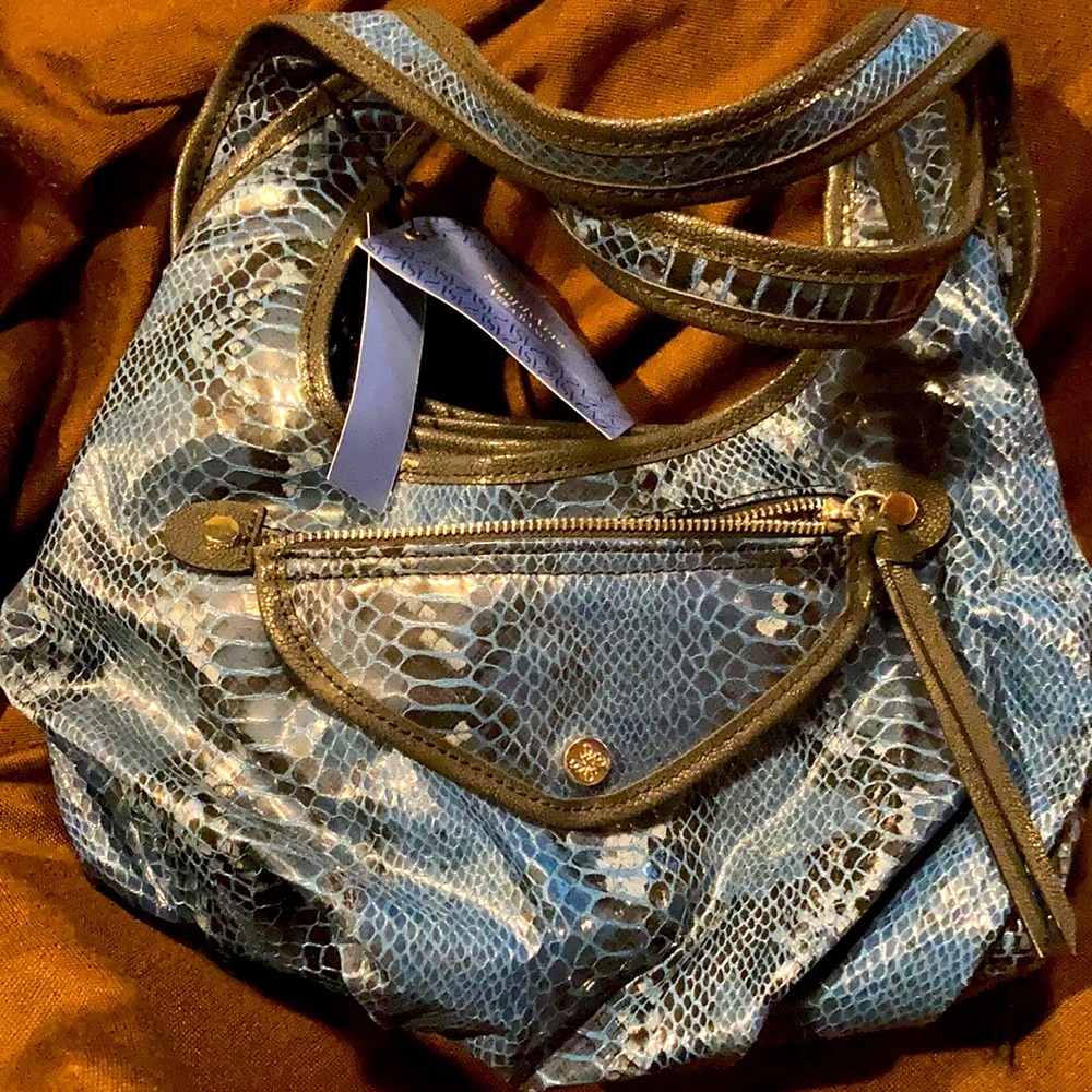 Navy blue purse with a lot of pockets.